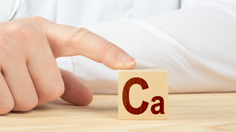 Doctor's finger touching a Ca (Calcium) block