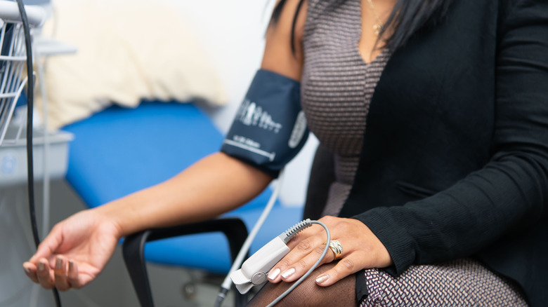 woman with blood pressure cuff