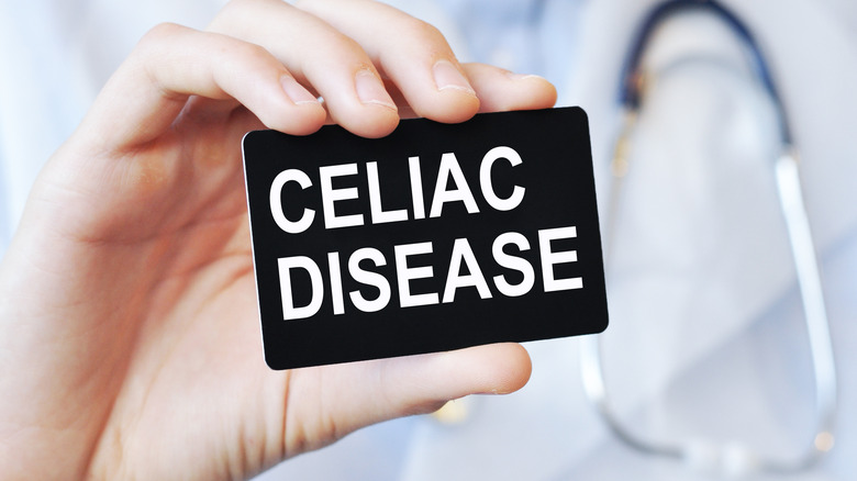 Doctor holding card that says "celiac disease"