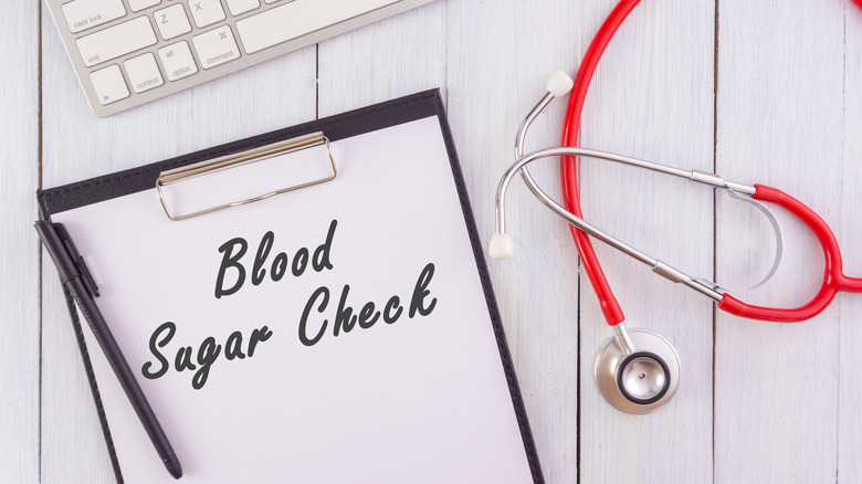 The words "Blood Sugar Check" on clipboard