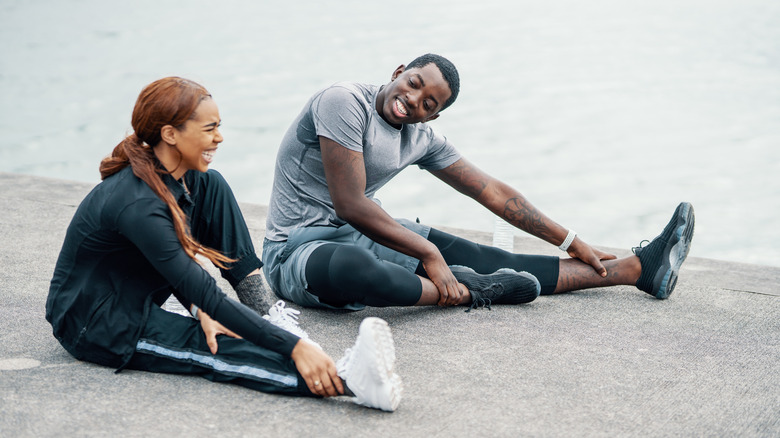 couple stretching their legs before a workout