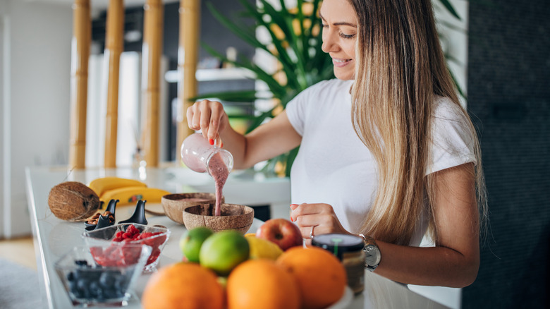 Woman making peanut butter smoothie