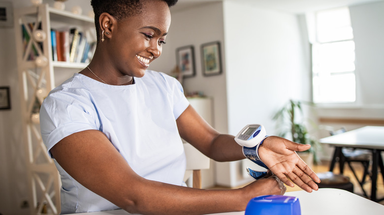 Woman measuring her blood pressure