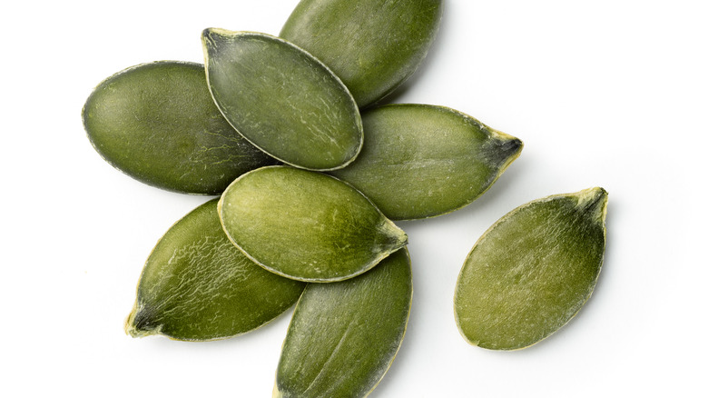 Pumpkin seeds against white background