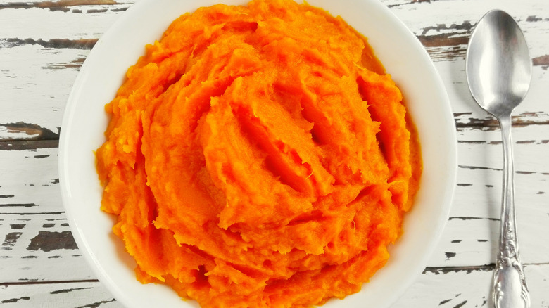 Bowl of pumpkin puree with spoon