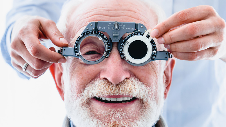 Elderly man receives an eye exam