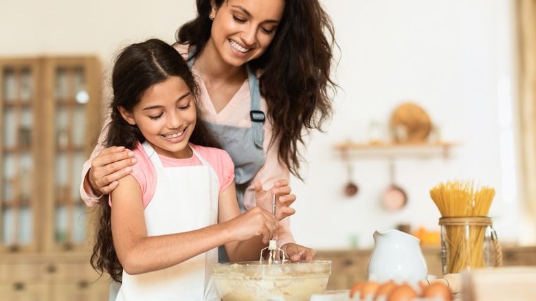 Woman and daughter making cookie dough