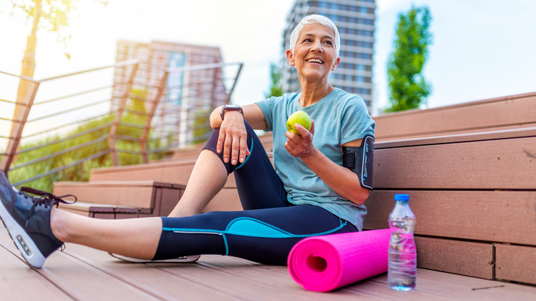 A woman enjoys a green apple