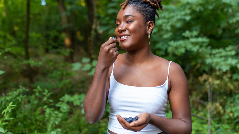 woman eating blueberries