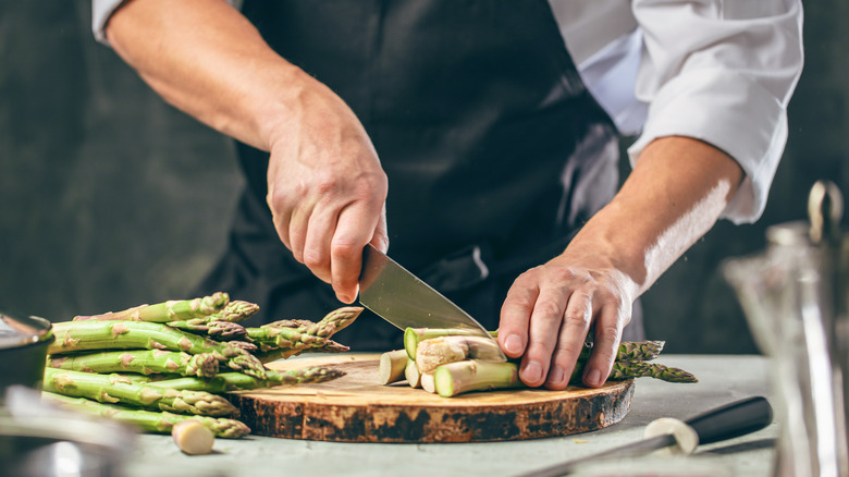 A chef prepares asparagus