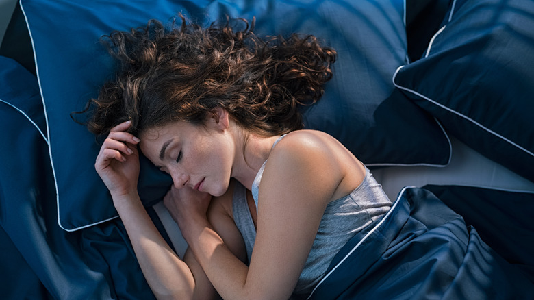 woman laying in bed asleep 