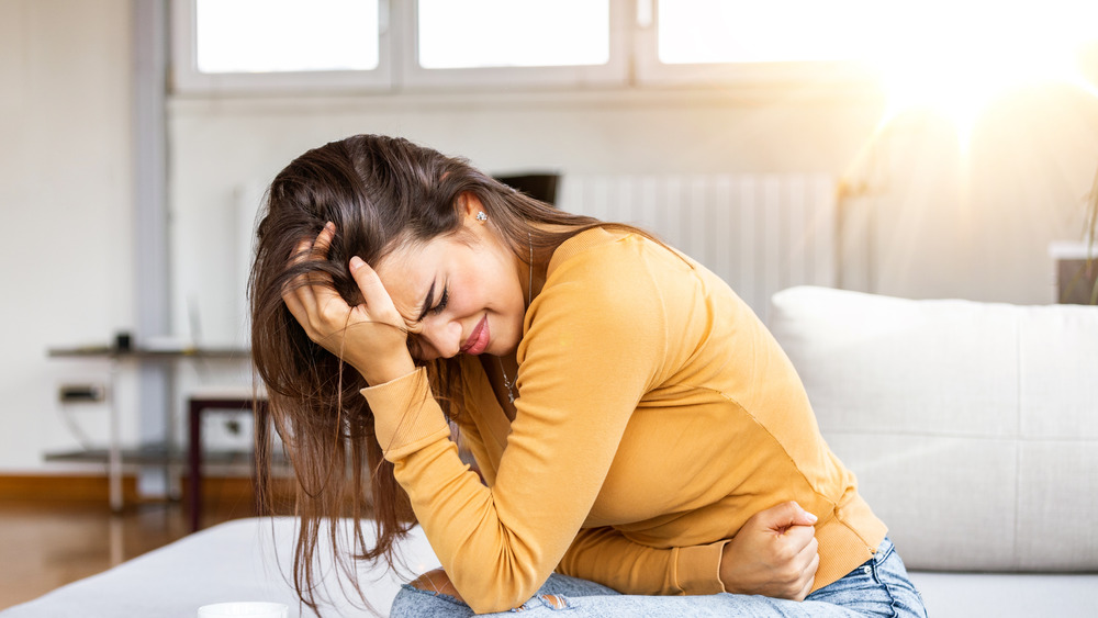 Woman clutching her stomach