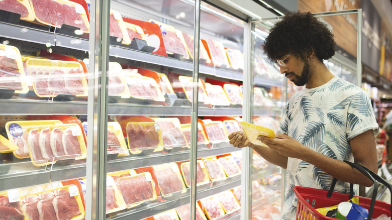 man buying meat grocery store