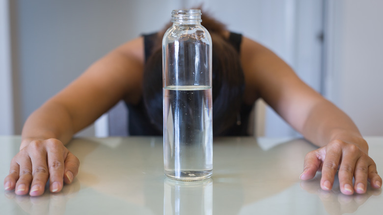 water bottle in front of woman