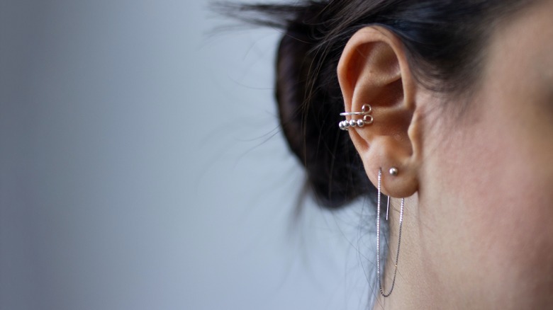 image of multiple piercings in woman's ear