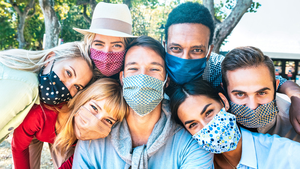 Social gathering of people wearing masks 