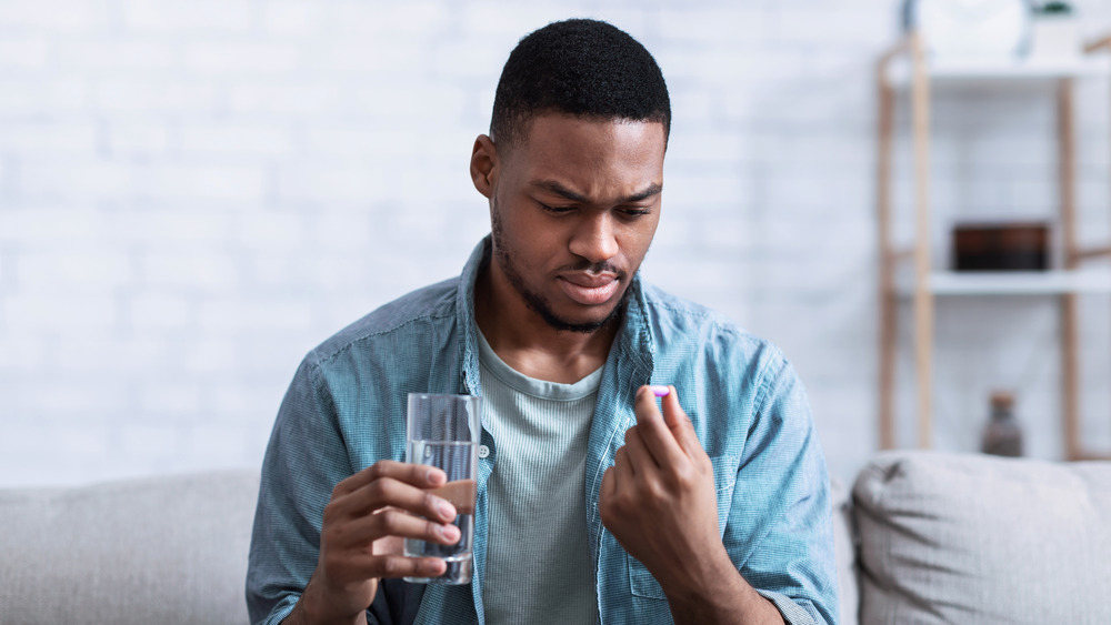 Man taking an acetaminophen