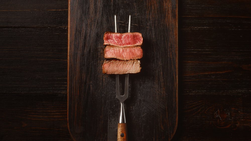 Raw steak on slate background