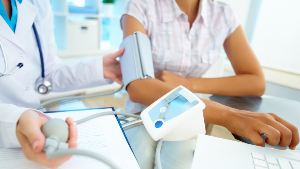 Person getting blood pressure checked at the doctor