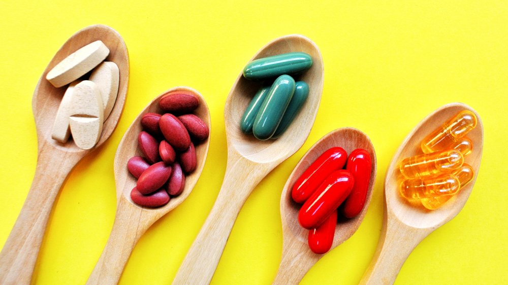 Vitamin capsules on spoons