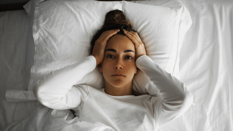 A woman lying in bed awake