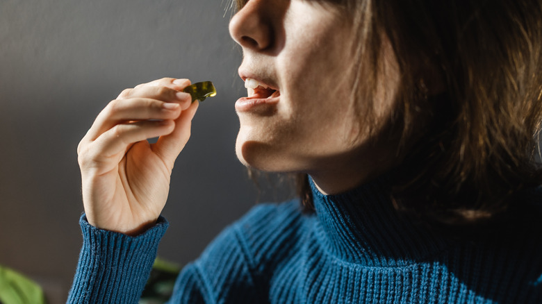 A woman eating a cannabis gummy