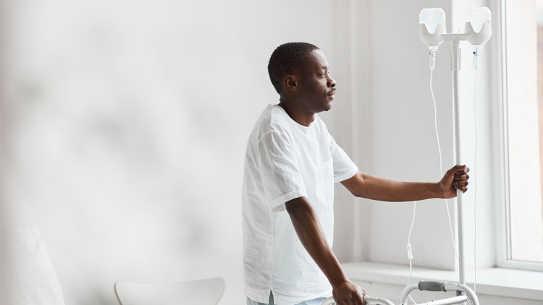 man walking with IV pole