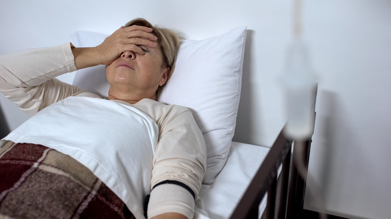 woman lying in hospital bed