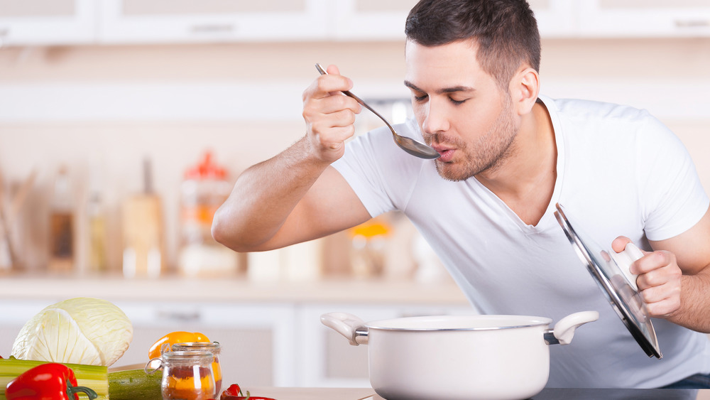 man tasting vegetable soup