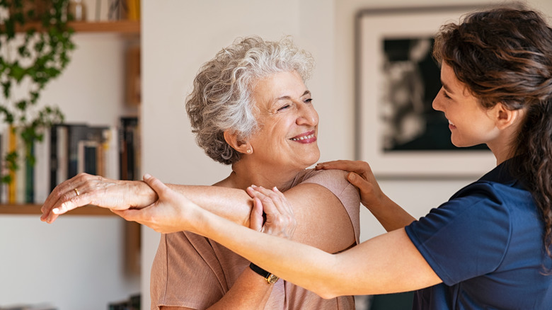 woman stretching with therapist