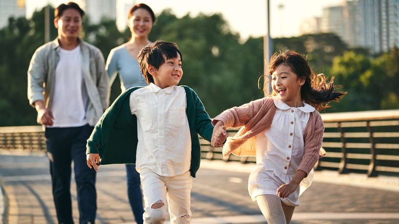 Parents and two young children having fun outdoors