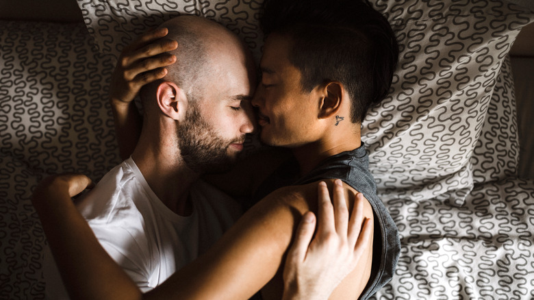 Romantic couple hugging in bed