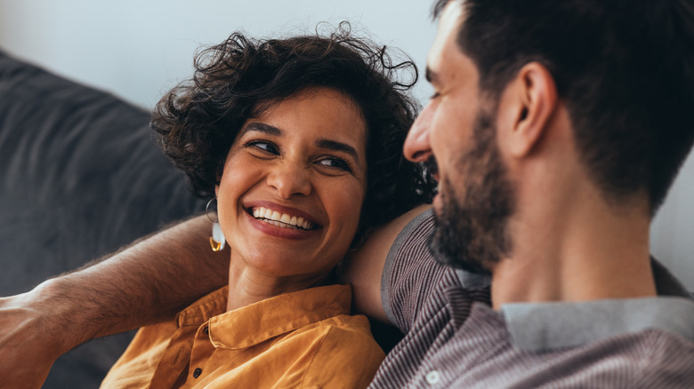 smiling woman and man on sofa