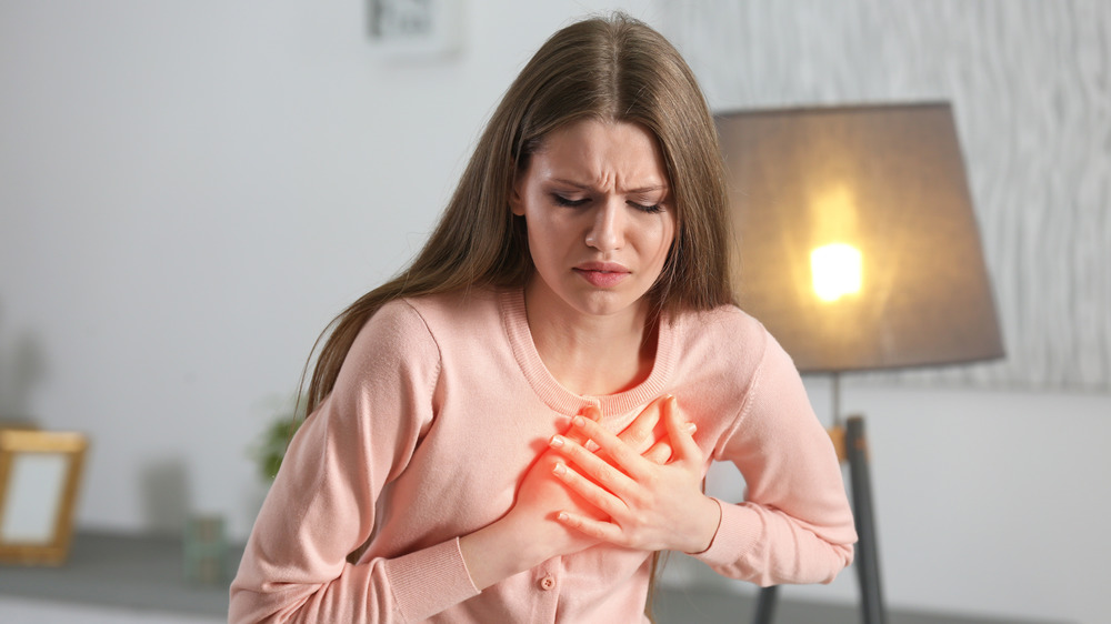 Woman suffering from chest pain