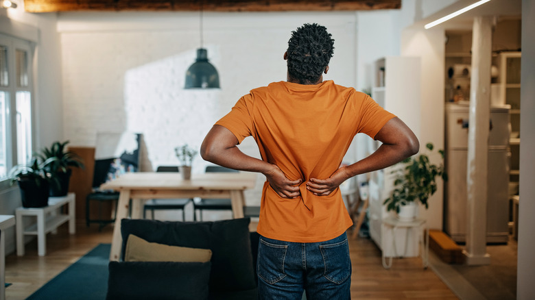 Man holding back with kidney pain