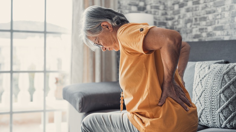 Woman holding her kidneys in pain