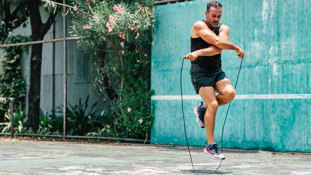 man jumping rope outside