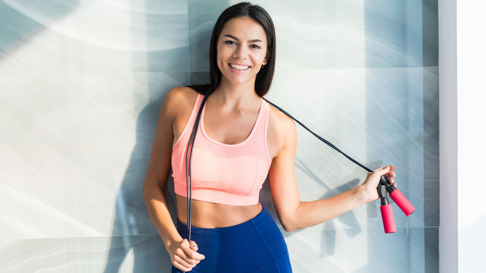 happy woman holding jump rope