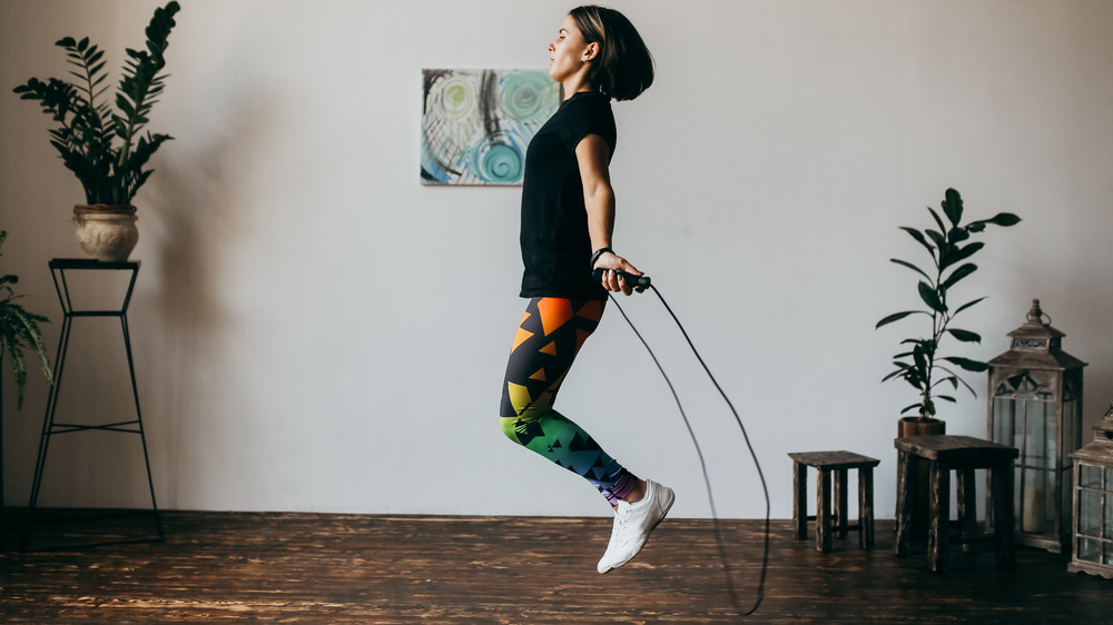 woman jumping rope at home