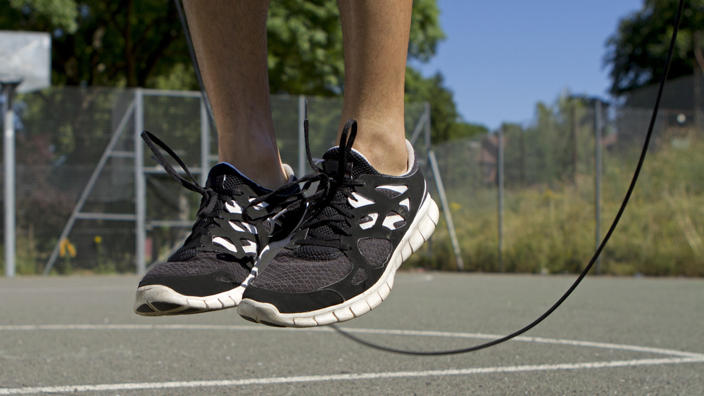 close-up on feet while jumping rope