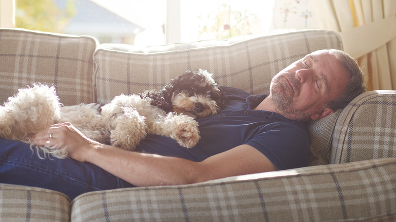 Man napping with dog