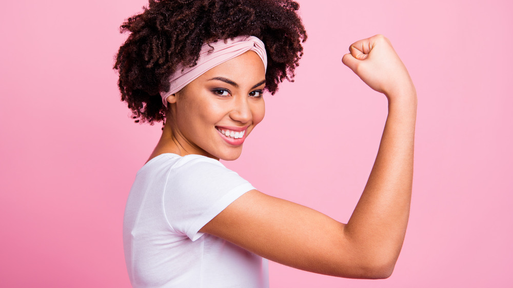 woman smiling and flexing