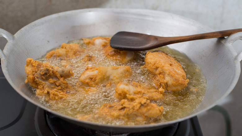 Fried chicken in pan of oil