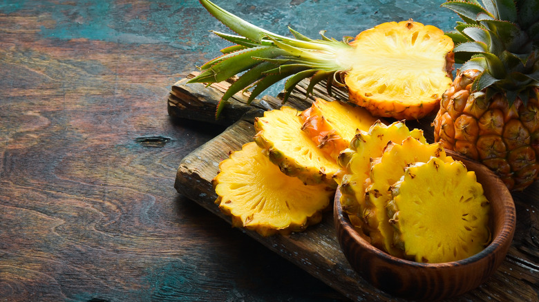 whole and sliced pineapple arranged