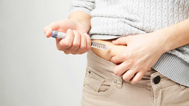 person taking diabetes insulin shot