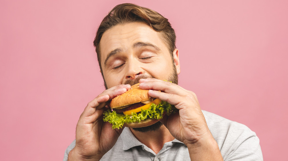 man eating burger