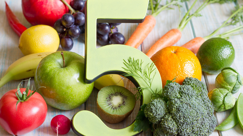 The number 5 in a pile of fruits and vegetables