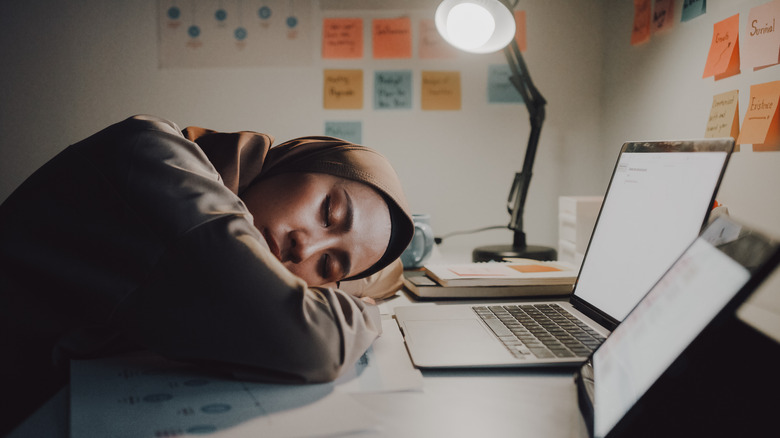 Woman sleeping on desk