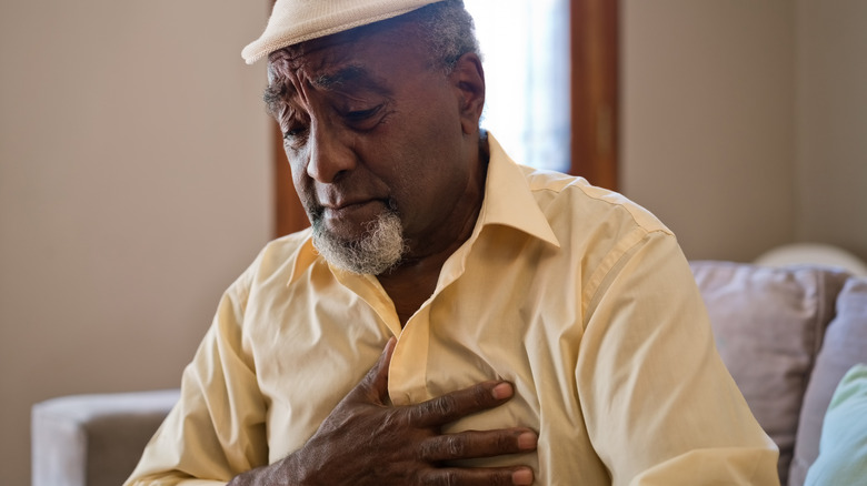 Man holding chest in pain