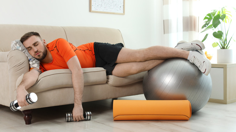 Man falling asleep while exercising